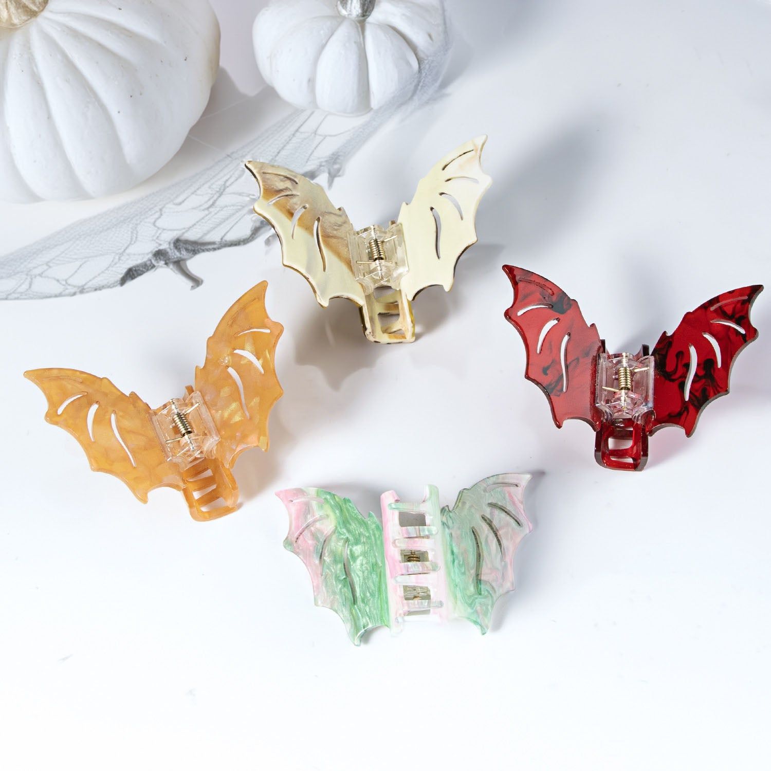 A collection of colorful bat-shaped claw clips, perfect Halloween hair accessories for women with a gothic style.