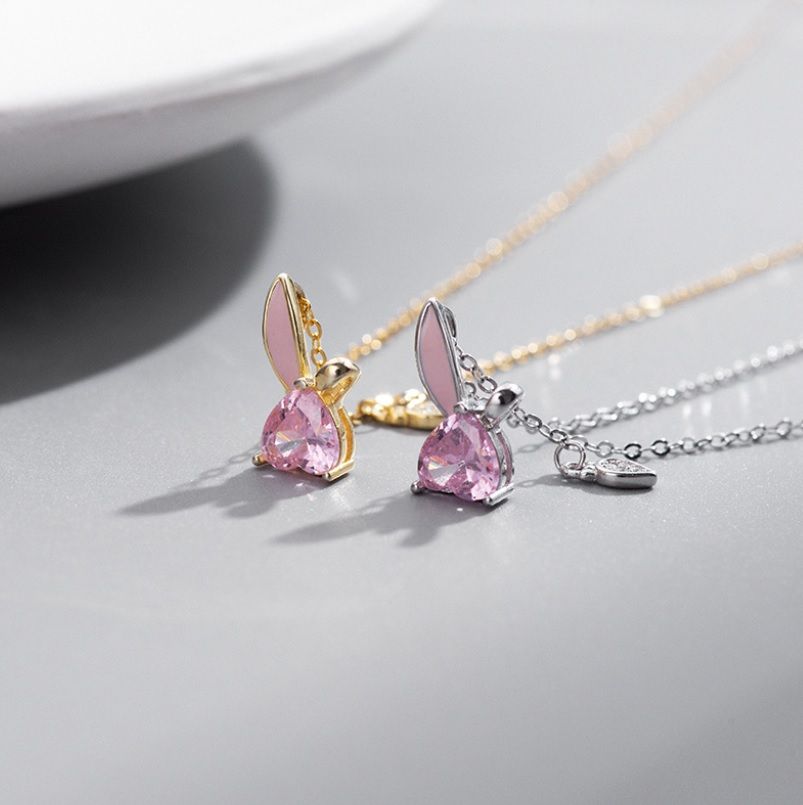A pair of 925 sterling silver bunny love necklaces, one in a silver finish and one in gold, both featuring charming bunny pendants with pink gemstone accents.