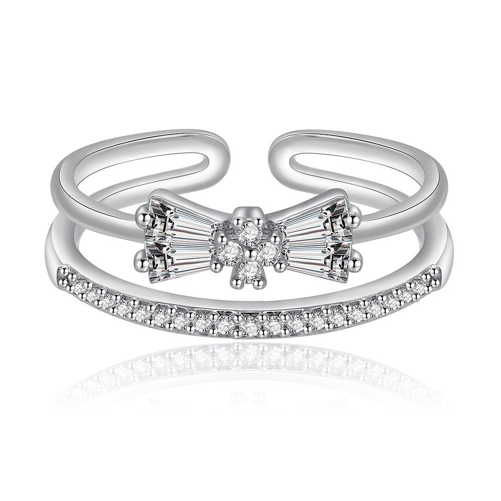 A close-up of the Glamorous Bow Ring, featuring a delicate bow design crafted from rhodium-plated brass and intricately set with sparkling cubic zirconia stones.