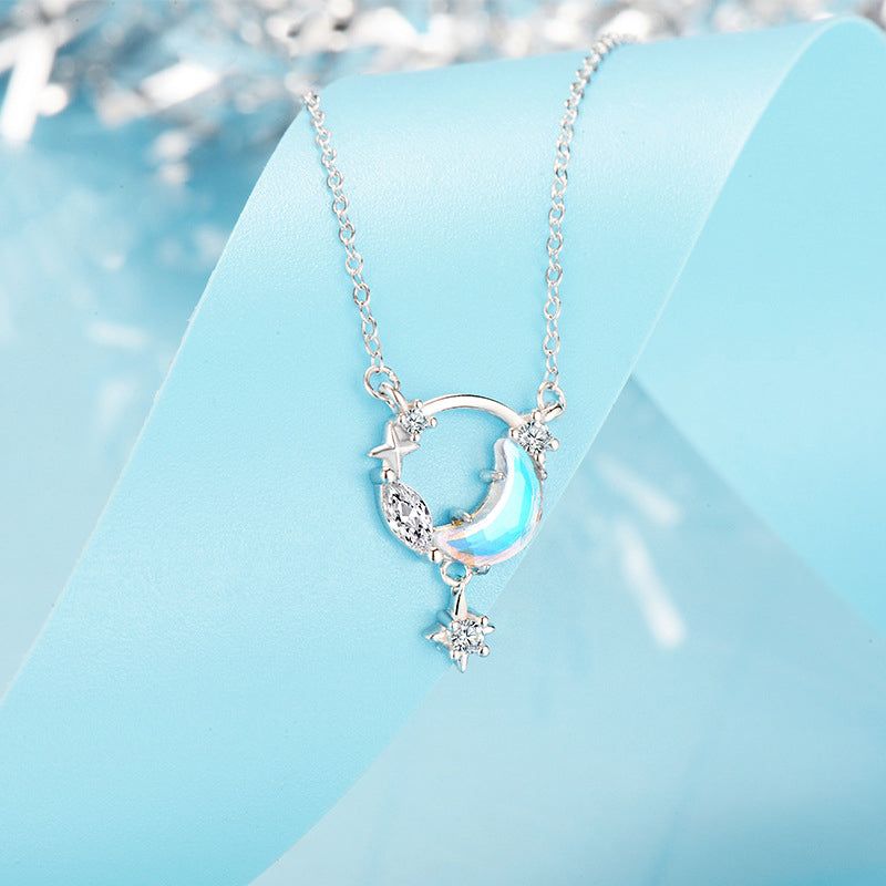 A detailed view of a 925 sterling silver necklace from the star and moon set, featuring a celestial-themed pendant with a crescent moon, stars, and a glowing blue stone.