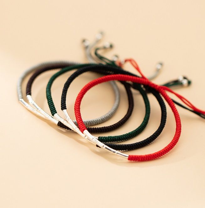 A collection of 925 Sterling Silver Bamboo Rope Bracelets displayed in six vibrant colors, each featuring a secure metal clasp.