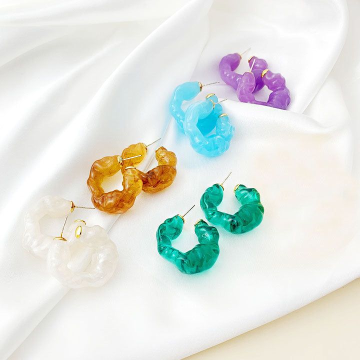 A vibrant collection of irregular ruffle resin C-shape stud earrings in multiple colors, displayed neatly on a white background.