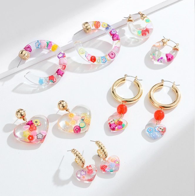A vibrant collection of Korean fashion fruit acrylic cute earrings, featuring clear resin with colorful embedded charms, displayed on a white background.