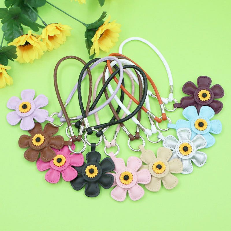 A colorful collection of sunflower PU leather keychains with tassels, available in various colors for wholesale.