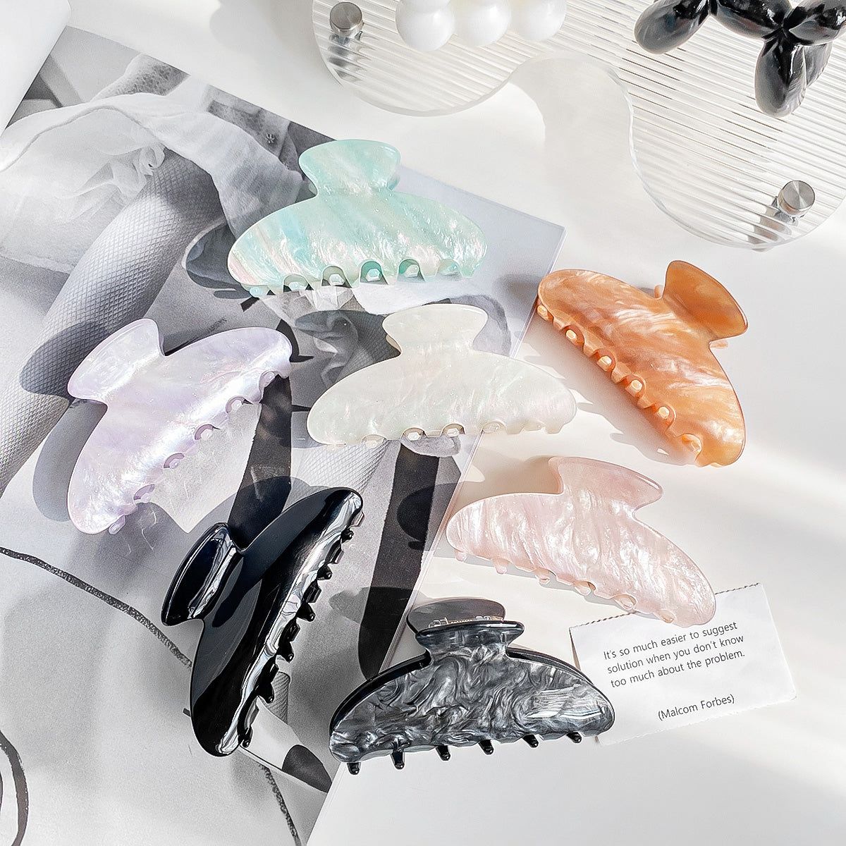 A vibrant arrangement of colorful acrylic acetate claw hair clips for women, available in a set of five.