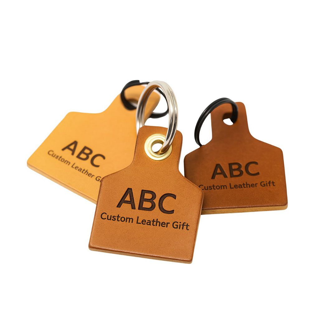 A collection of custom leather keychains in a cow tag design, showcasing the craftsmanship of JR Fashion Accessories, a wholesale manufacturer.
