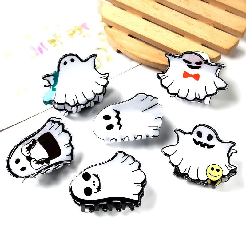 A collection of white ghost-themed claw hair clips with various cute and spooky facial expressions, displayed for wholesale by JR Fashion Accessories.