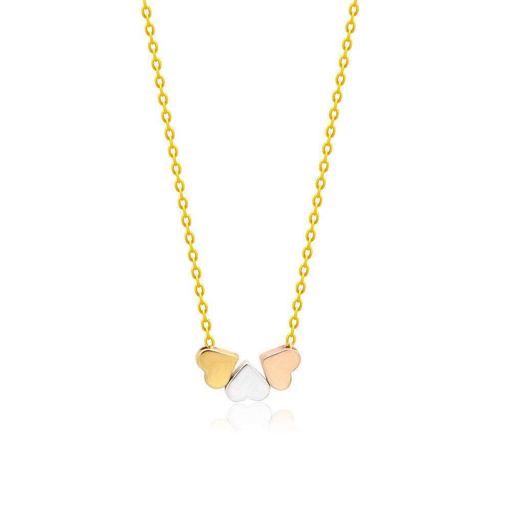 A close-up of the elegant Triple Heart Necklace, showcasing the three interlocking heart pendants in rhodium, gold, and rose gold plating on a delicate brass chain.