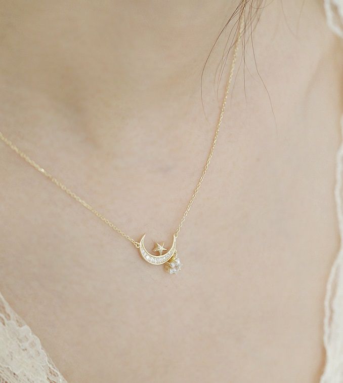 A close-up of the 925 Sterling Silver Moon Star Necklace, showcasing the detailed gold-plated crescent moon and star pendant set with sparkling cubic zirconia stones.