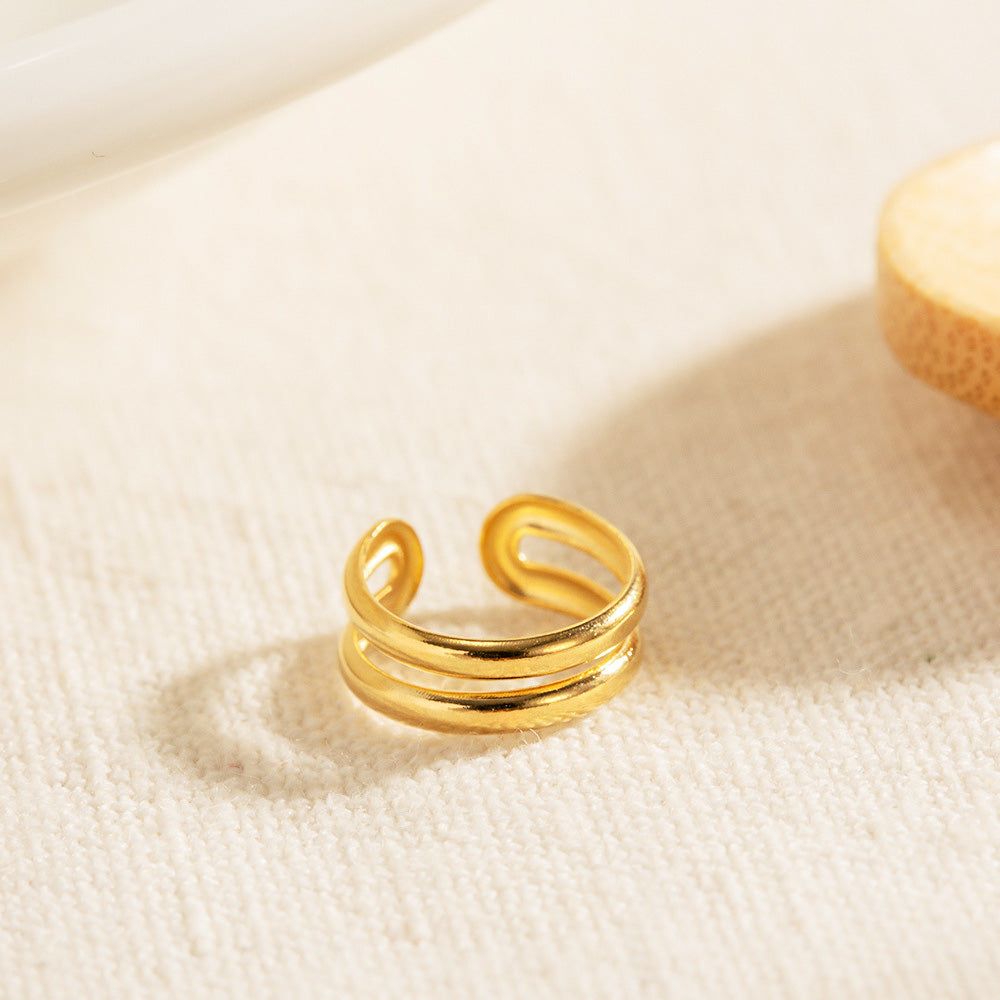 A close-up of the stainless steel gold double-layer cartilage ear cuff, highlighting its polished finish and modern, non-piercing design.