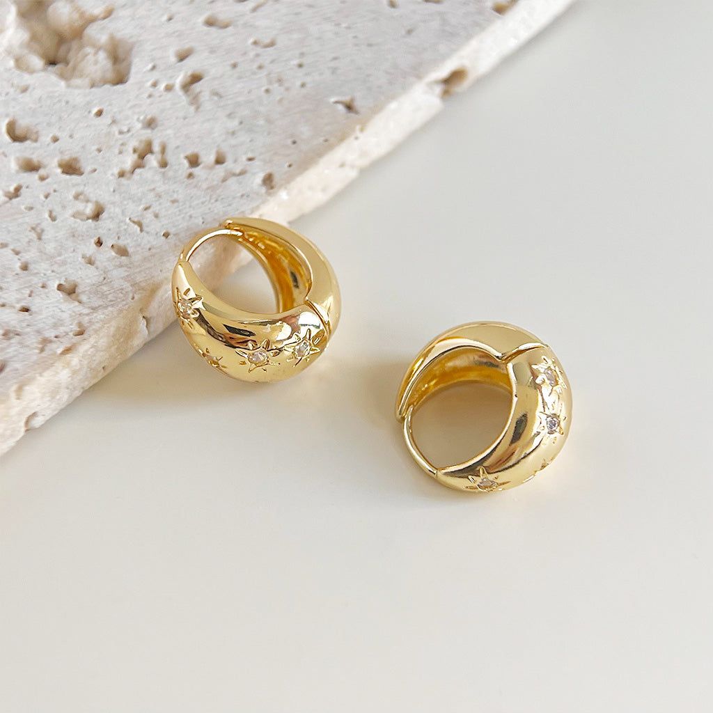 A close-up of the 14k gold-plated zircon inlaid bucket-shaped hoop earrings, showcasing the sparkling stones and high-quality brass material.