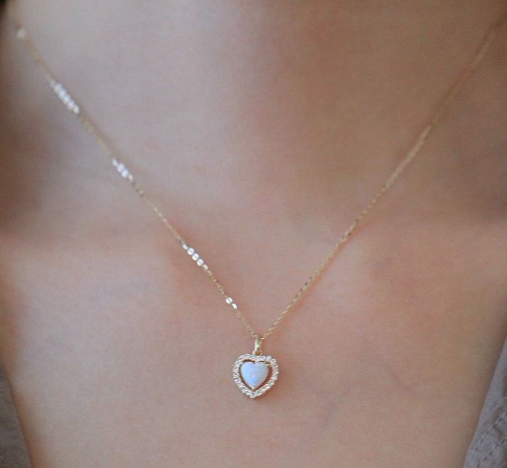 Close-up of a 925 Sterling Silver Heart Opal Necklace, showing the intricate gold-plated heart pendant with a central opal stone.
