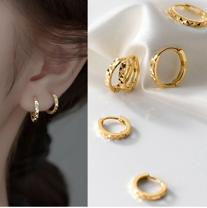A model wearing the 925 Sterling Silver Gold Plated Diamond Cut Hoop Earrings, showcasing their elegant design and fit.