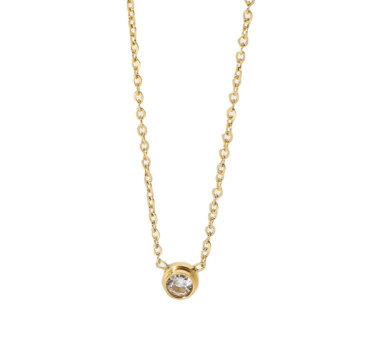 A close-up of the Delicate Round Solitaire Necklace, showcasing its brilliant clear crystal pendant on a fine gold-plated stainless steel chain.