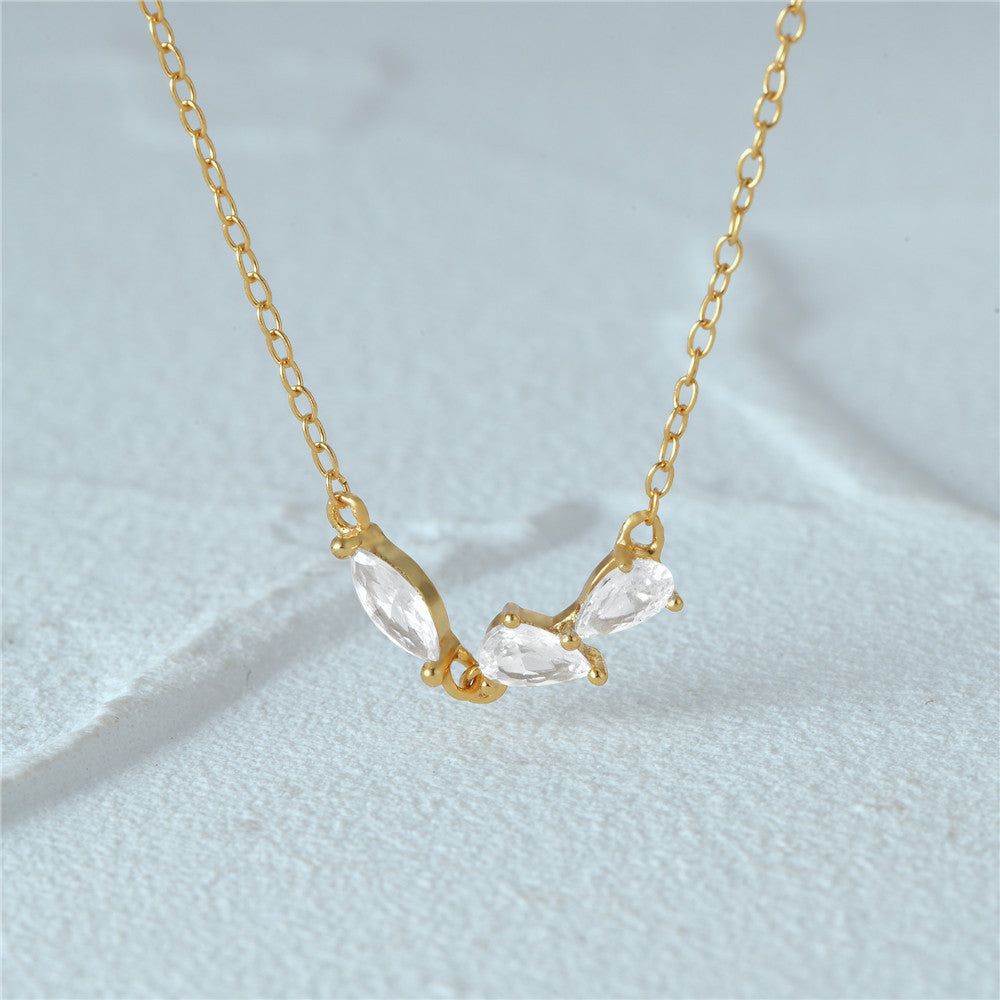 A close-up of the 925 silver geometric cluster zircon necklace in a radiant gold finish, showcasing the sparkling crescent-shaped pendant.