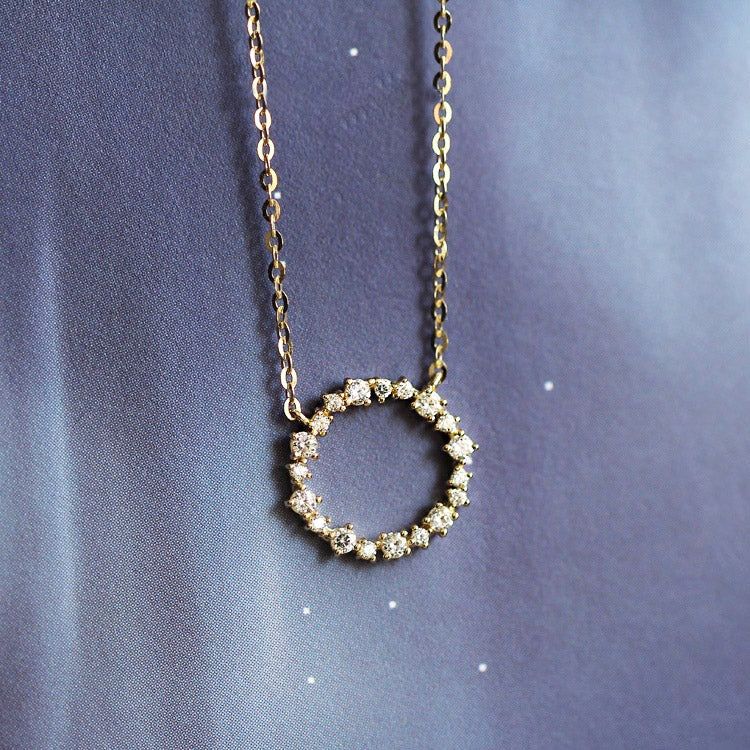 A close-up of the 925 sterling silver zircon wreath pendant necklace, highlighting the sparkling stones set in a circular design.