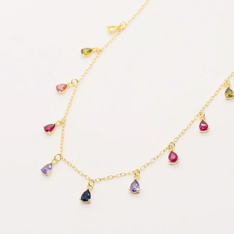 A close-up of the 925 Sterling Silver Rainbow Dangling Teardrop Necklace, showcasing its gold chain and vibrant, multicolored gemstones.