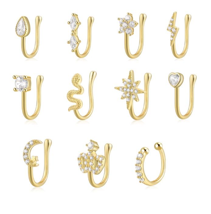 Una collezione di fermagli per naso in argento sterling 925 con placcatura in oro, caratterizzati da vari design con pietre in zirconia cubica.