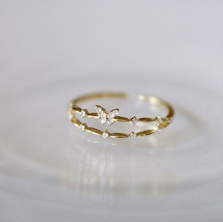 A close-up of the 925 Sterling Silver Adjustable Butterfly Ring in a gold finish, highlighting the detailed butterfly design and sparkling cubic zirconia stones.