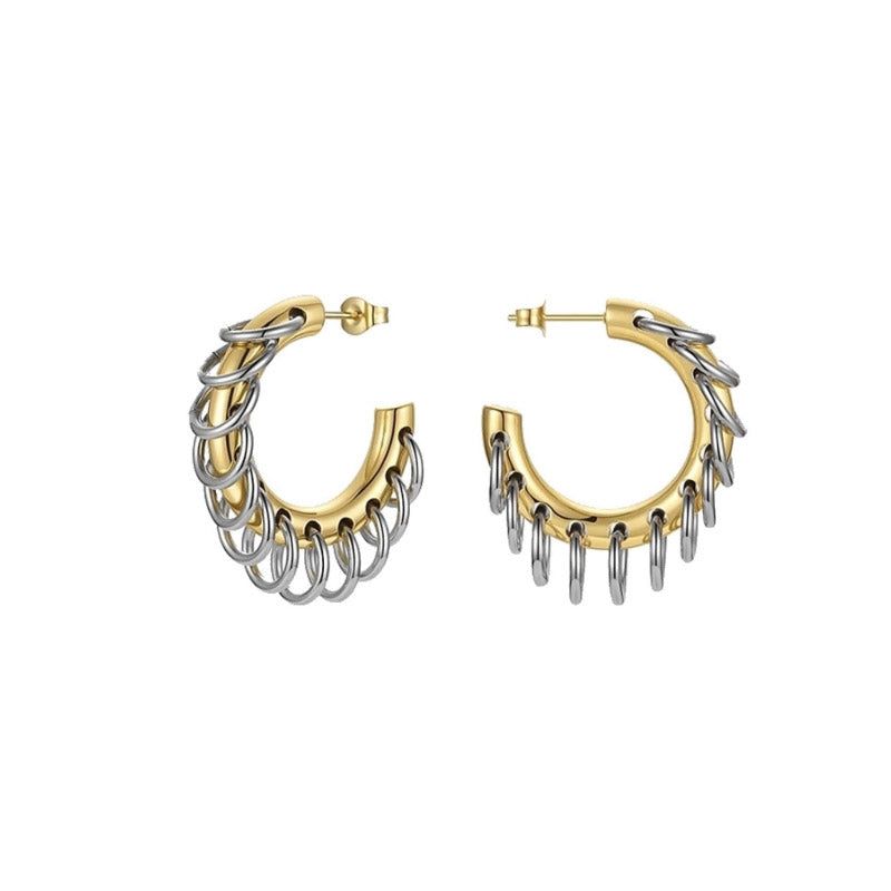 Een paar roestvrijstalen punk hoepeloorbellen met een twee-kleurig gouden en zilveren ontwerp, met hangende kettingtassels, op een schone witte achtergrond.