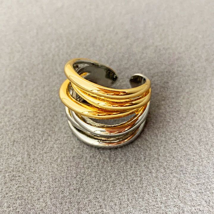 A stylish set of gold and silver stackable brass rings with a vintage, multi-layered design, showcasing the two-tone finish.