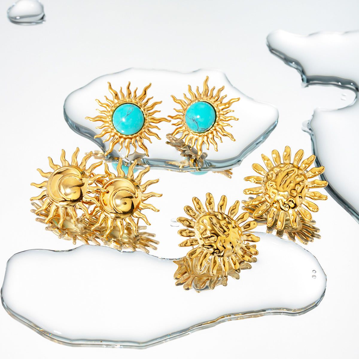 A collection of stainless steel gold-plated sun design stud earrings, some featuring vibrant turquoise stones, displayed on a white background.