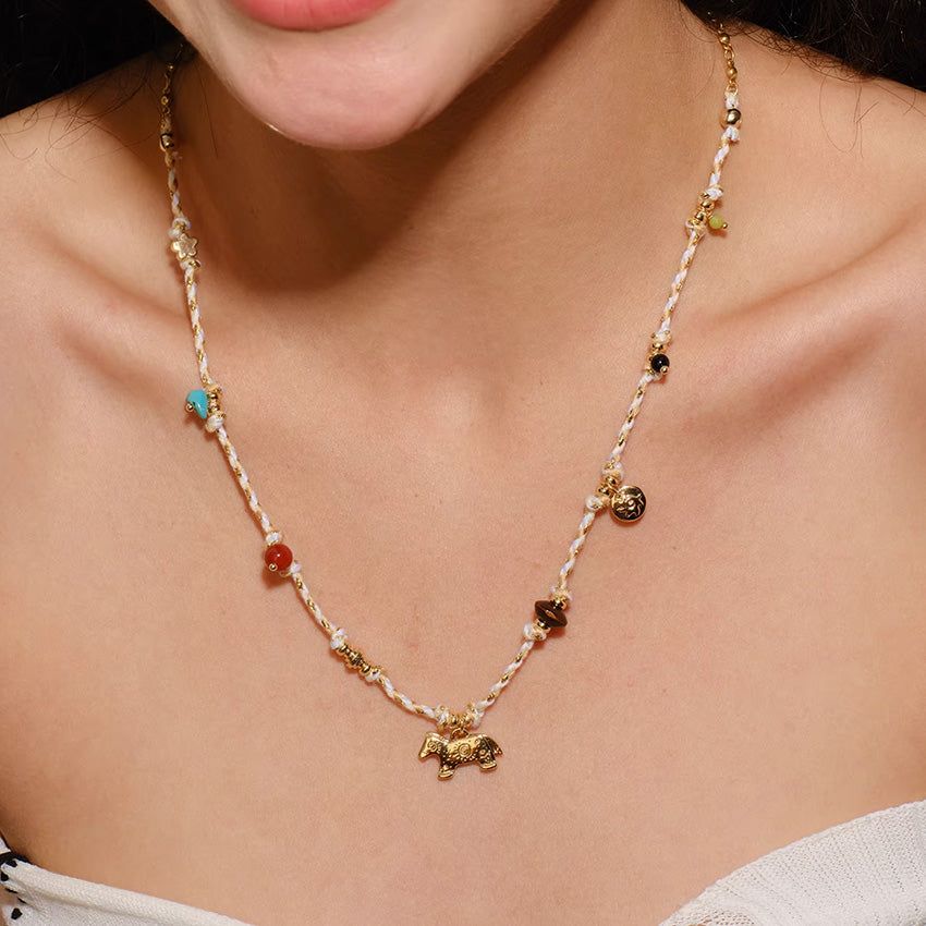 A model wearing the bohemian natural stone beaded rope necklace with a gold horse pendant, showcasing its collarbone length.