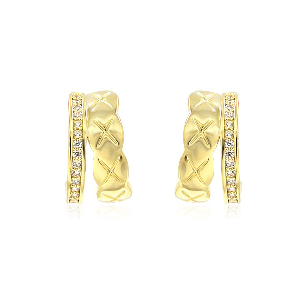 Un primo piano degli orecchini a cerchio con placcatura in oro giallo, che mette in mostra il design attorcigliato e gli accenti di zirconia cubica scintillante.