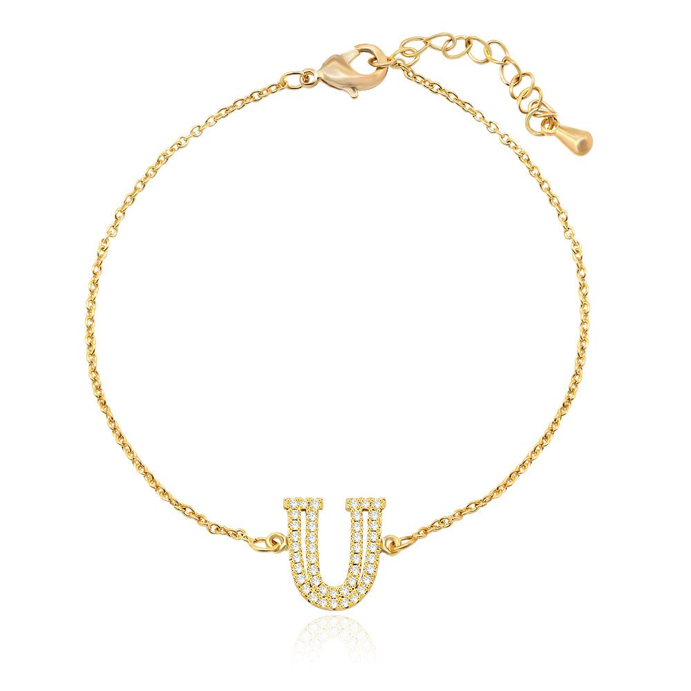 Close-up of the Diamond Alphabet Initial Bracelet in gold, showcasing the U-shaped charm set with brilliant cubic zirconia stones.