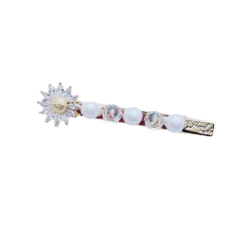 A close-up of the Sunflower Pearl Crystal Hair Pin, showcasing its intricate gold-plated sunburst design adorned with sparkling crystals and elegant white pearls.