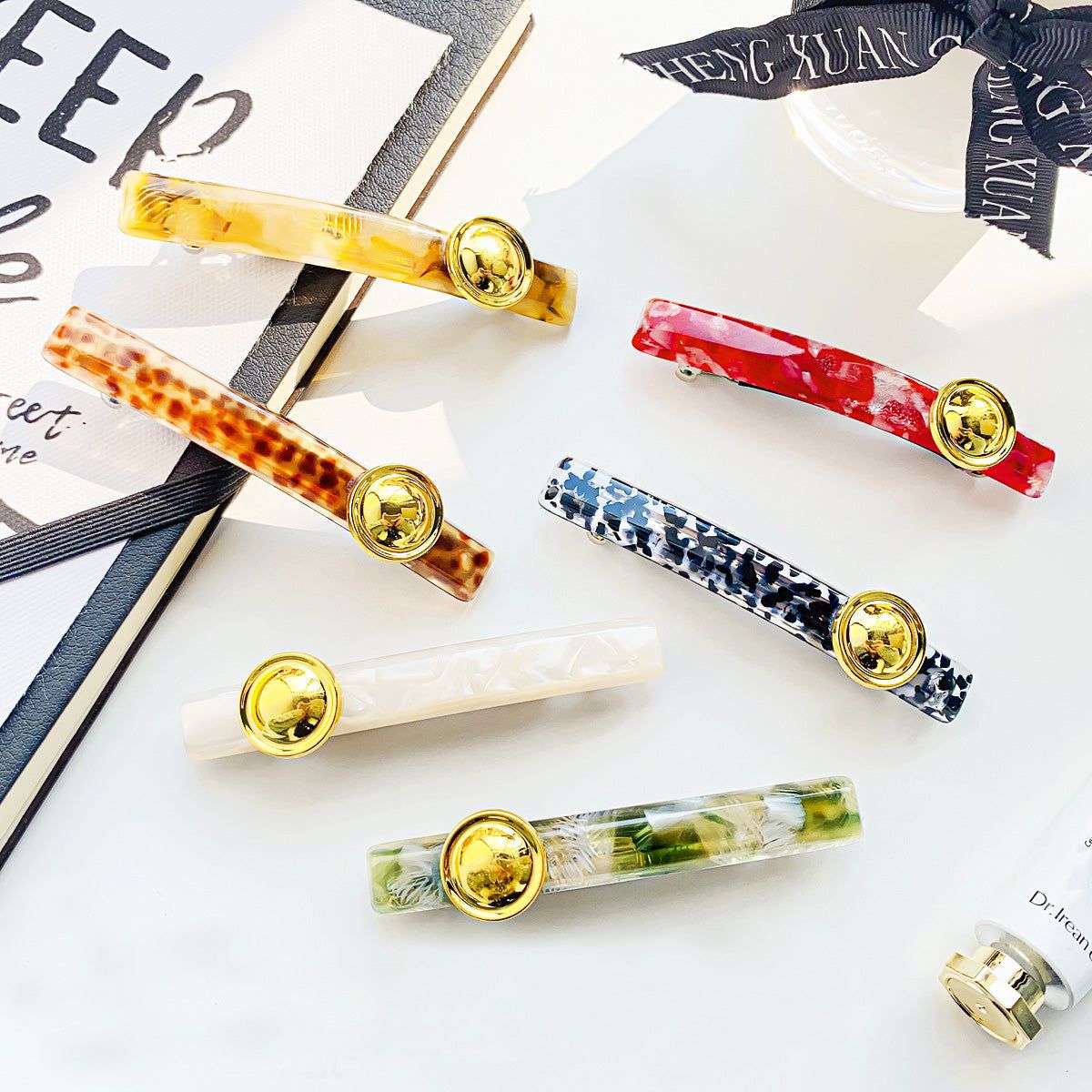 A collection of stylish leopard print acetate French barrette hair clips in various colors, displayed on a neutral background.