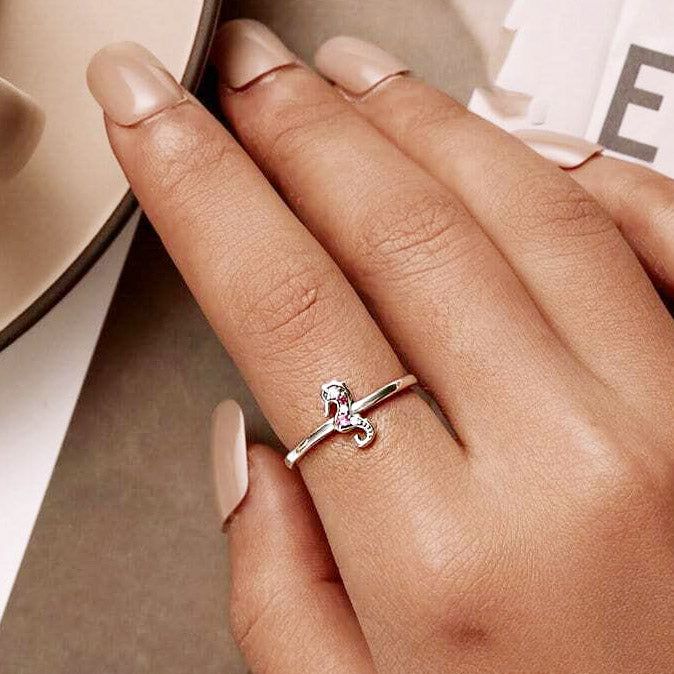 A close-up of a woman's hand wearing a beautiful 925 sterling silver heart-shaped ring, showcasing the quality of the adjustable ring set.