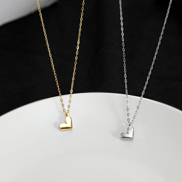 A set of minimalist heart-shaped necklaces in both 925 sterling silver and gold finishes, displayed side-by-side.