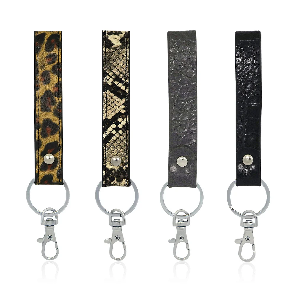 A collection of four stylish leather keychains with animal prints and elegant metal hardware, available for wholesale from JR Fashion Accessories.