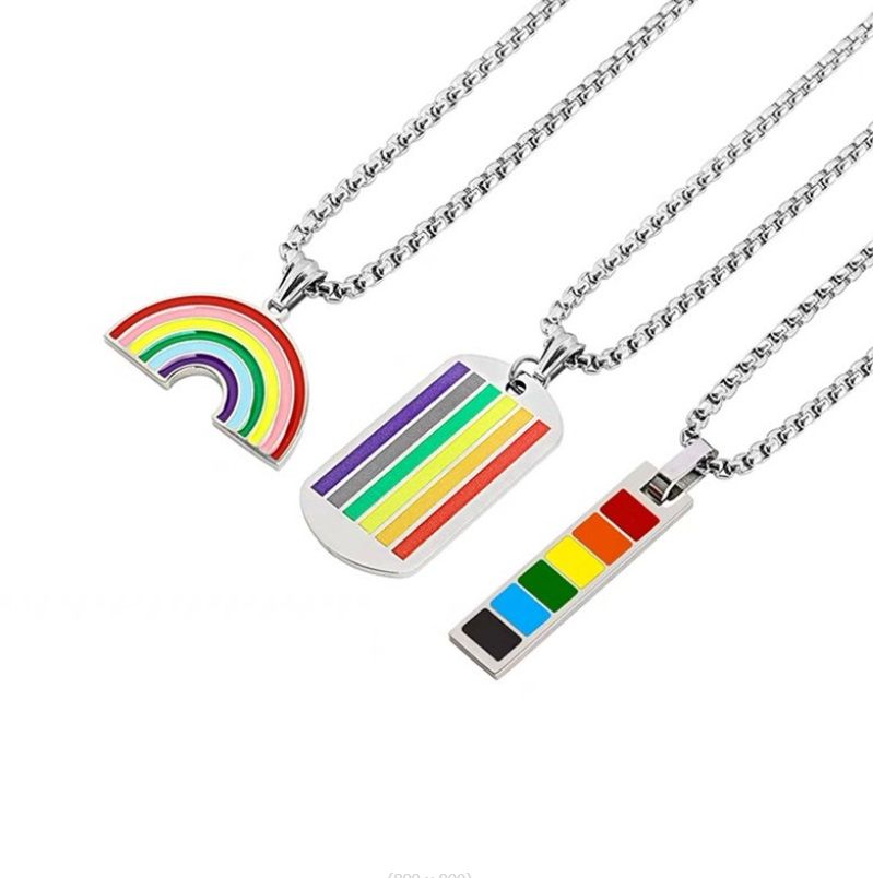 A collection of three stainless steel LGBT Pride necklaces, each featuring a unique rainbow enamel pendant design, displayed on a clean white background.
