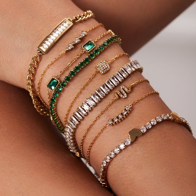 OEM Gold Plated Bangle made from stainless steel, shown with other luxury bracelets.