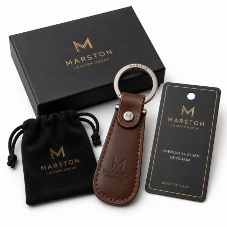 Bespoke Marston brown leather keychain with debossed logo, velvet pouch, and premium packaging.