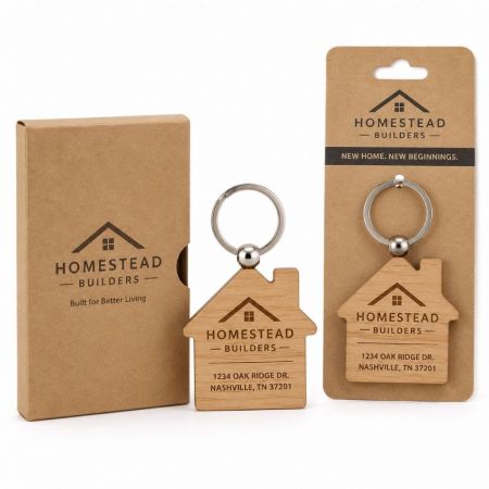 House shaped wooden keychain with laser engraved logo real estate closing gift on cardboard backer and box.