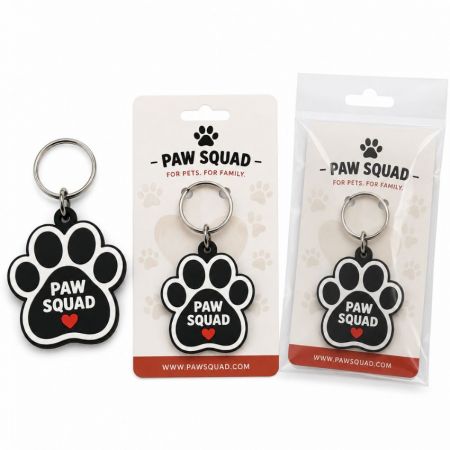 Custom PVC rubber paw print keychain with brand logo card stock backing and clear poly bag retail packaging.