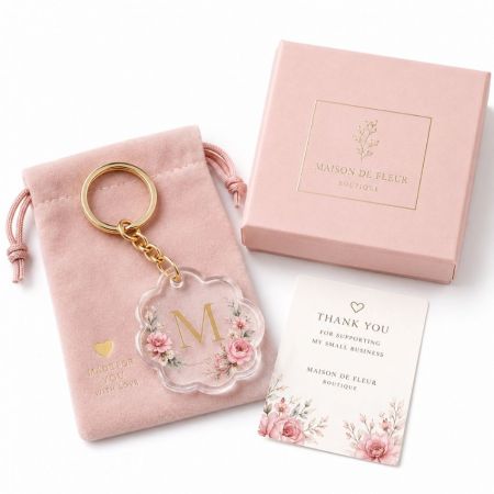 Custom floral acrylic monogram keychain with gold chain pink velvet pouch thank you card and gift box.
