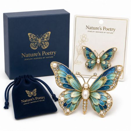 Enamel butterfly brooch set in blue and green with pearl accents featuring branded display card and box.