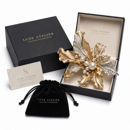Luxe atelier couture statement gold flower brooch with elaborate pearl stamen and velvet jewelry pouch.