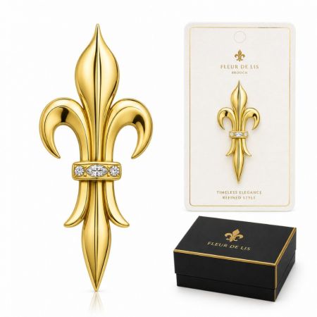 Elongated gold fleur-de-lis brooch with marquise crystal accent, timeless elegance jewelry manufacturing showcase.