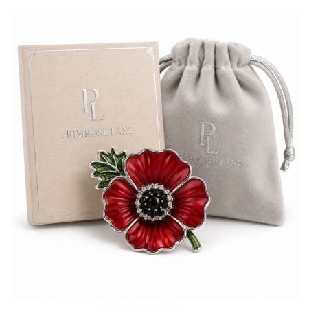 Primrose Lane silver-toned red poppy brooch alongside branded card and velvet drawstring pouch for wholesale.