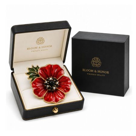 Bloom & Honor red enamel poppy pin with diamond accents inside an open leatherette jewelry display case.