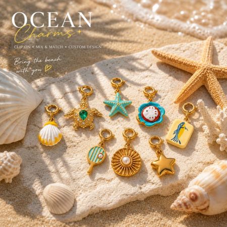 A collection of sea turtle and starfish gold charms on a textured coastal stone for wholesale jewelry buyers.