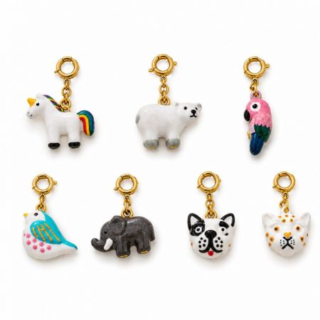 Seven styles of enamel animal clip-on charms with gold-plated rings, ideal for wholesale custom jewelry merchandising.