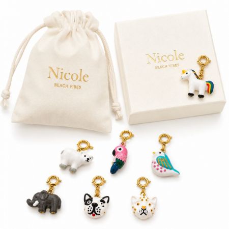 Custom packaging box and cloth pouch printed with logo alongside colorful enamel animal charm clips for OEM ODM brands.