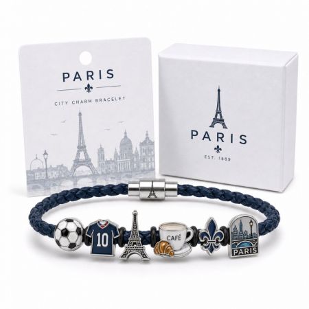 Paris city charm bracelet in dark blue leather featuring custom enamel Eiffel Tower and coffee cup souvenirs.
