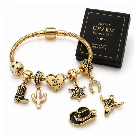 Custom cowboy theme charm bracelet with gold boot, cactus, and hat charms next to a premium retail gift box.